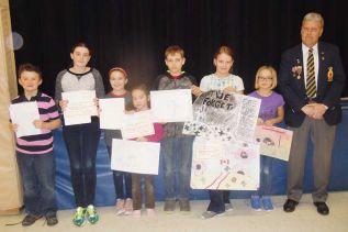 Arden Legion branch president Peter DesRoche with seven of the eight students at LOLPS who were presented with second place awards and honourable mentions in this year’s Legion Zone G1 essay and poster contests.